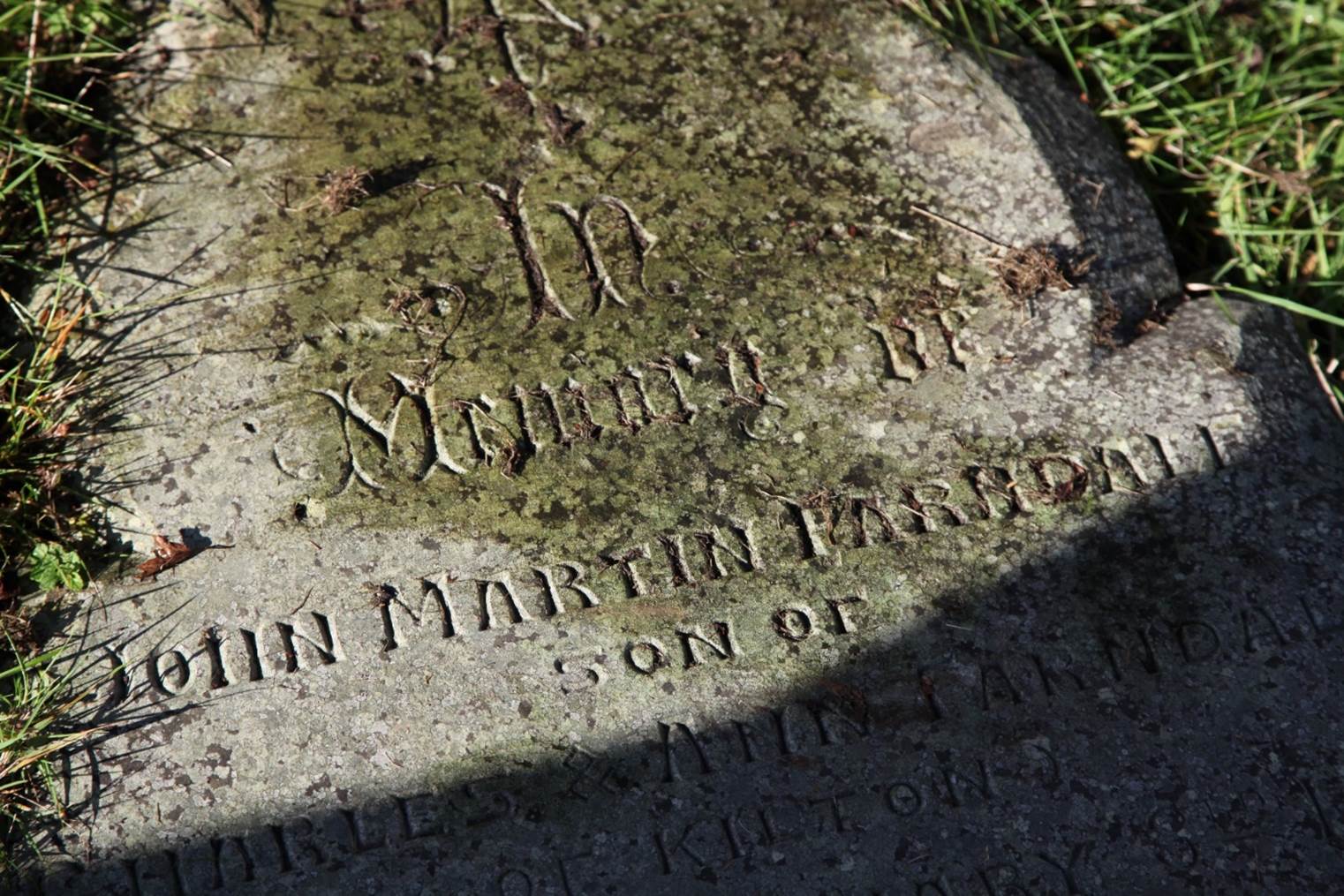 A close-up of a tombstone
Description automatically generated